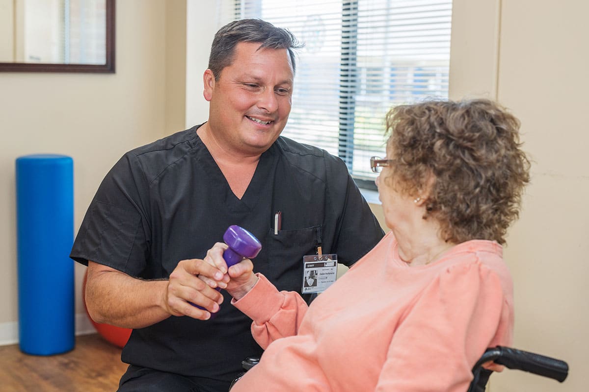 A Rehab therapist in the Rehab gym at the Piedmont Post Acute facility